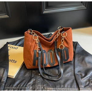 Detail of caramel suede tote bag with HOOTD letter embroidery and gold chain strap