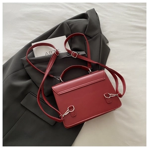 Detail of dark red matte leather backpack back with adjustable silver metal hardware