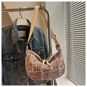 Detailed view of the woven canvas striped texture and adjustable shoulder strap on tote bag