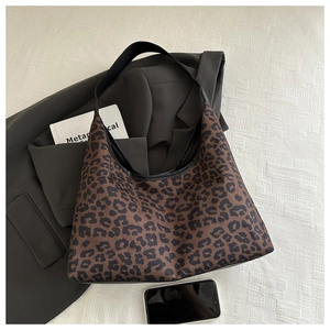 Chic leopard print hobo tote bag styled with a grey suit for a fashionable daily look