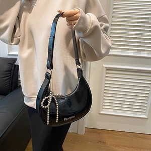 Minimalist black glossy crescent shoulder bag with pearl bow charm and Fashion logo