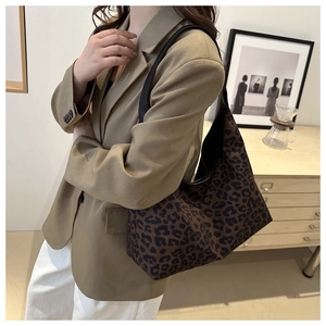 Detailed view of leopard print tote bag styled with a professional casual outfit