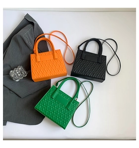 Three minimalist quilted leather crossbody bags in orange, green, and black colors