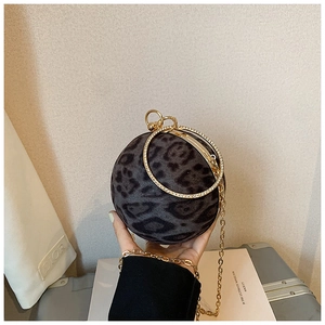 Detail of leopard print spherical handbag with rhinestone handle and gold chain