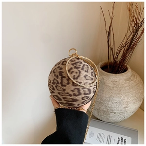 Detail of leopard print ball clutch with gold rhinestone handles and chain strap