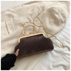 Detailed view of vintage suede shell bag with glittering rhinestones and gold kiss-lock