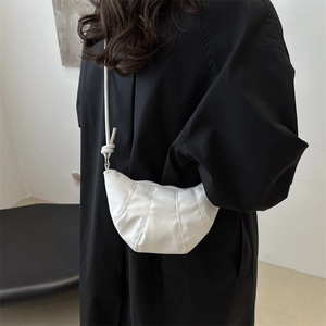 Fashionable white quilted half-moon shoulder bag with knot detail on high-quality matte leather