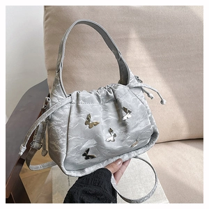Détail du sac bandoulière argenté plissé avec boucles papillon et fermeture cordon