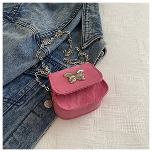 Detailed view of pink butterfly buckle and marbled texture on crossbody bag