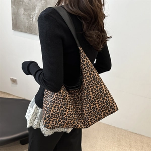 Chic leopard print large capacity tote bag with black leather shoulder straps on model