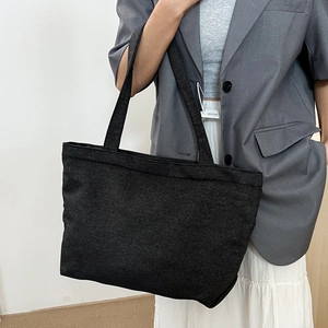 Minimalist black denim tote bag for women with spacious capacity and reinforced straps