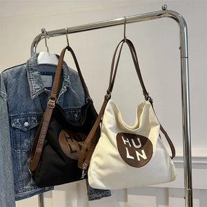 Large autumn canvas tote bags in black and cream with HULN letter print and brown straps