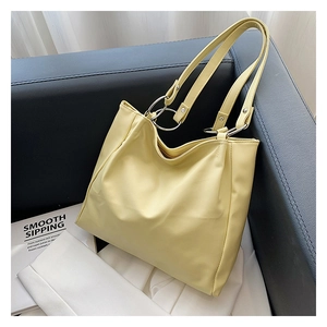 Detail of soft cream tote bag featuring stylish silver double metal rings on the strap