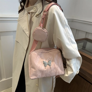 Pink pleated crossbody bag with silver butterfly charm and matching mini coin purse