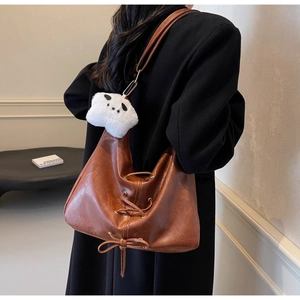 Brown large capacity tote bag with lace-up detail and panda charm on shoulder