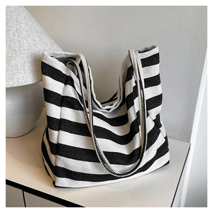 Detailed view of black and white striped canvas tote bag showing thick woven fabric texture
