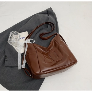 Detail of vintage brown tote bag with embossed number 10 and side pocket feature
