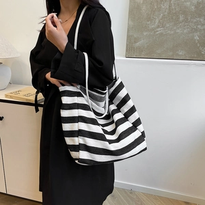 Chic black and white striped canvas tote bag with rope handles for casual daily use
