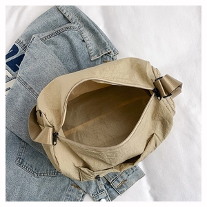 Top view of spacious nylon crossbody bag interior with zip closure and beige lining