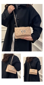 Close-up of beige quilted texture and silver bow detail on fashionable chain crossbody bag