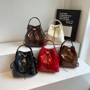 Glossy leather bucket backpacks with butterfly metal buckles in five varied colors
