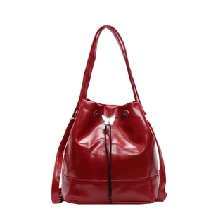 Glossy red faux leather bucket bag with silver butterfly buckle and drawstring closure
