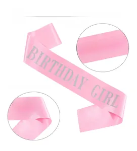 Detailed view of pink satin birthday girl sash with sparkling silver glitter lettering