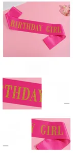 Detail of pink satin birthday girl sash featuring shiny gold glitter lettering and texture
