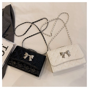 Quilted crossbody bags with metal bow buckle and chain strap in black and white