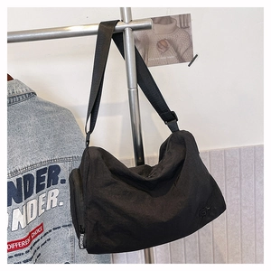 Detail of waterproof black nylon crossbody bag with fashion zipper and wide strap