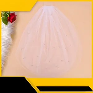 Short double-layer white bridal veil with rhinestones and comb on a decorative background