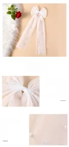 Detailed view of white bridal tulle bow hair ribbon featuring elegant pearl embellishments
