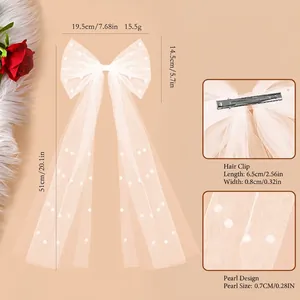 Elegant white tulle bow hair clip with pearls and long ribbons for bridal hairstyles