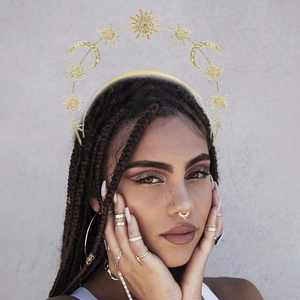 Detail of baroque gold star and moon headband with rhinestones on a bohemian model