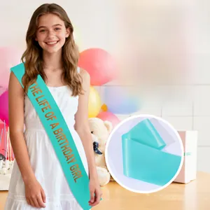 Detail of blue satin sash with orange text The Life of a Birthday Girl for party decor