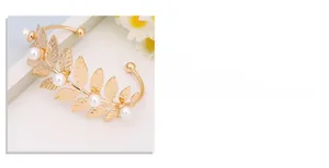 Detailed view of adjustable gold leaf arm cuff with white pearls and polished finish