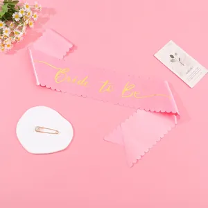 Pink satin Bride to Be sash with gold script lettering for bridal shower party decorations