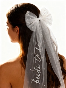 Close-up of pearl bow bridal veil with Bride to Be lettering and delicate mesh detail