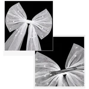 White bridal bow hair clip with mesh veil and pearls for weddings and parties