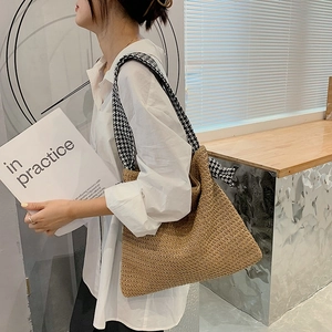 Minimalist woven straw tote bag with black and white houndstooth fabric shoulder strap