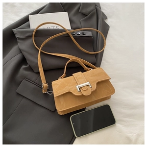 Detail of a bright yellow retro square bag with leather texture and silver buckle