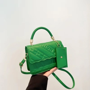 Detail of bright green quilted handbag with FASHION lettering and detachable coin purse