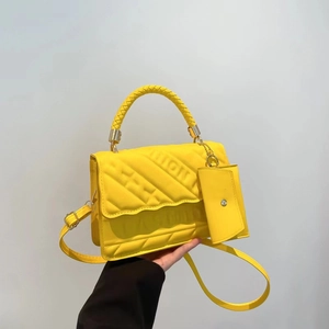 Bright yellow embossed fashion handbag with woven handle and matching mini coin purse
