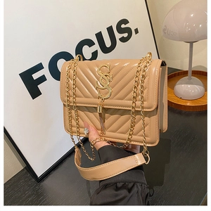 Detail of beige V-quilted faux leather bag with gold SS logo and chain strap