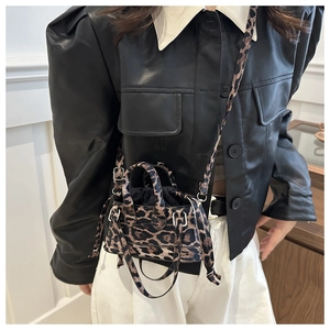 Detail of mini leopard print handbag with drawstring lining and silver hardware details