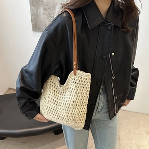 Retro cream woven crochet bucket bag with brown leather shoulder strap on model
