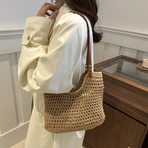 Handwoven beige cotton mesh tote bag with dark brown leather straps for beach holidays