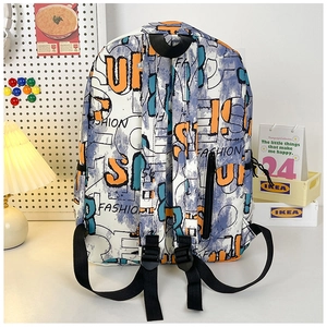 Detail of graffiti print backpack with adjustable black straps on a desk