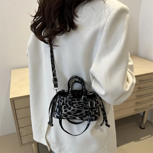 Chic leopard print mini crossbody bag with top handle and stylish drawstring details