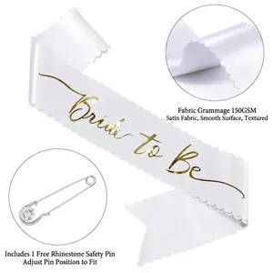 White satin Bride to Be sash with gold foil lettering and rhinestone safety pin accessory